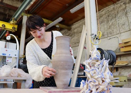 KU student Teresa Wright creating a ceramic vase